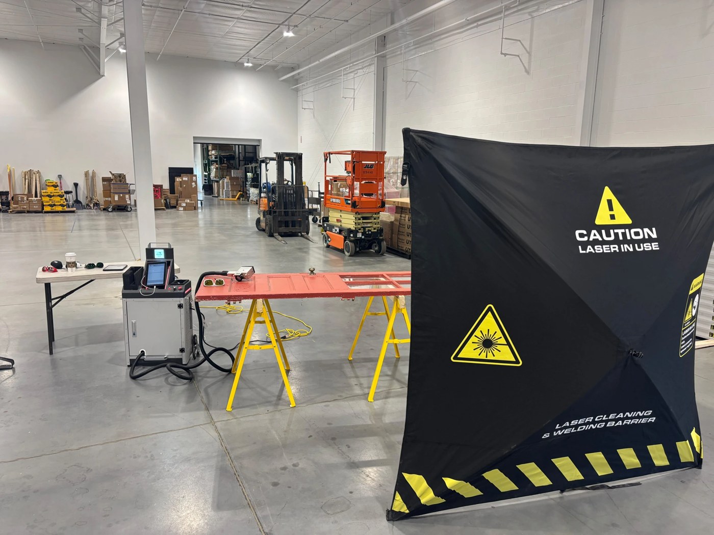 ALR laser cleaning demonstration with a laser safety barrier at a rental facility