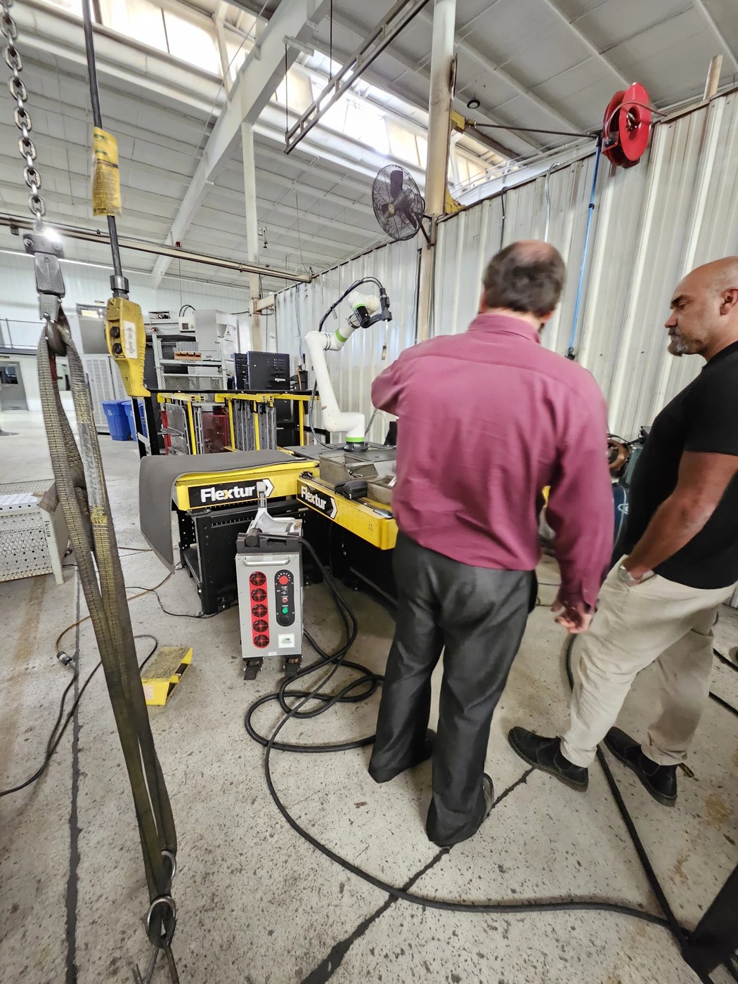Attendees evaluating the ALR laser cleaning equipment at Flextur