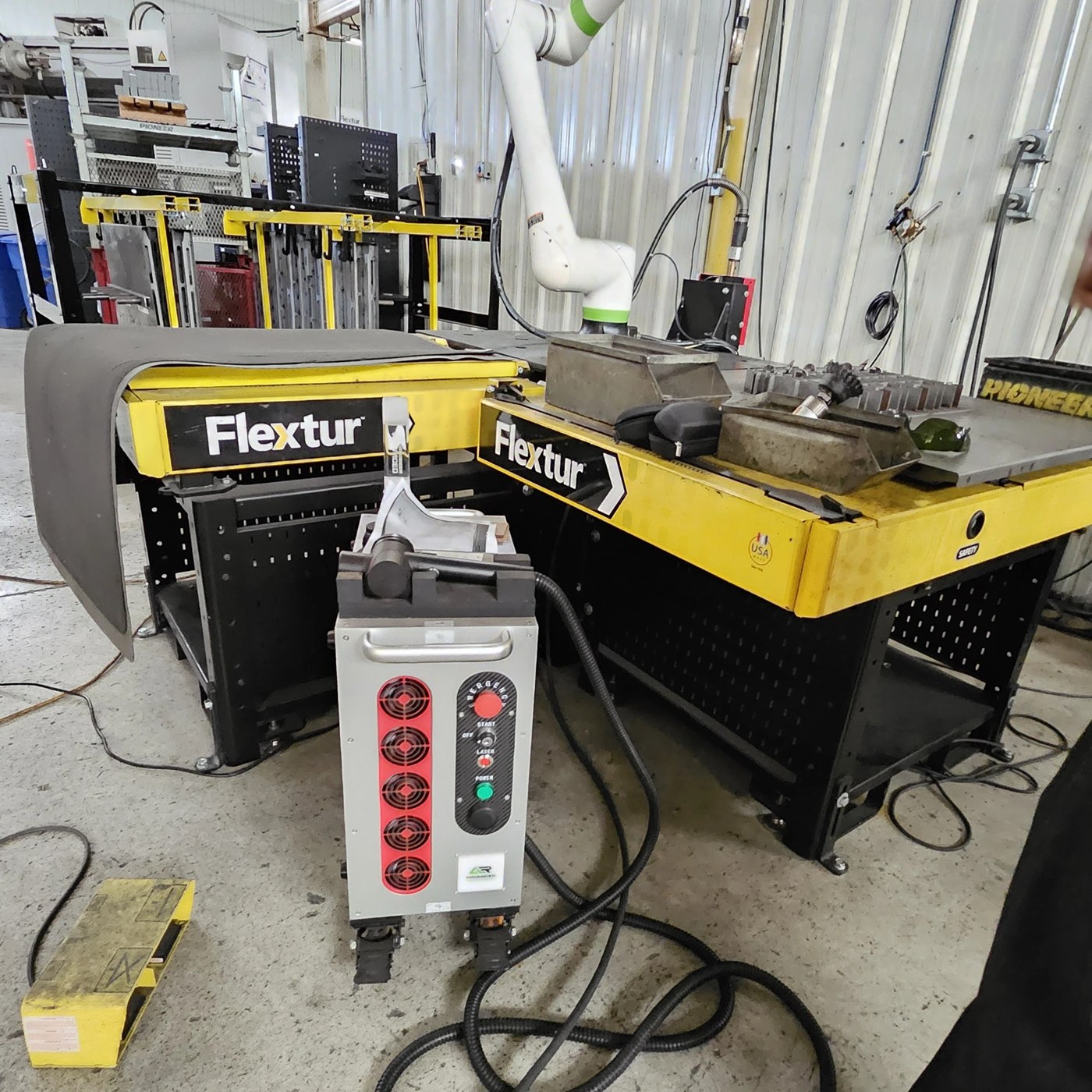 ALR laser cleaning machine beside Flextur welding tables